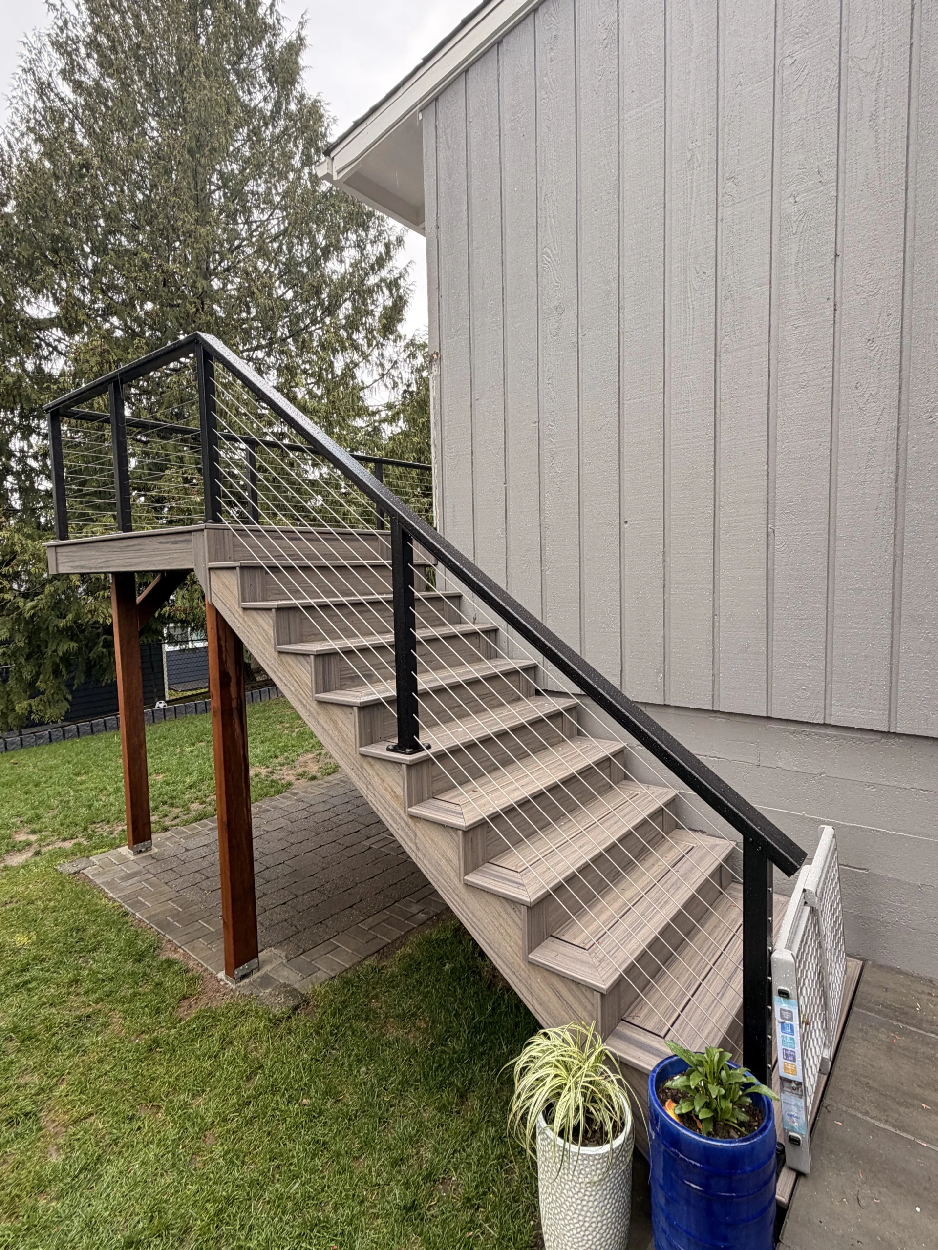 Trex Transcend Second-Story Deck Stairs With Black Cable Railing At A Seattle Home.
