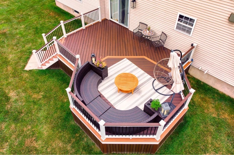 Modern Multi-Level Composite Deck With Curved Outdoor Furniture Built By Olympic Decks.