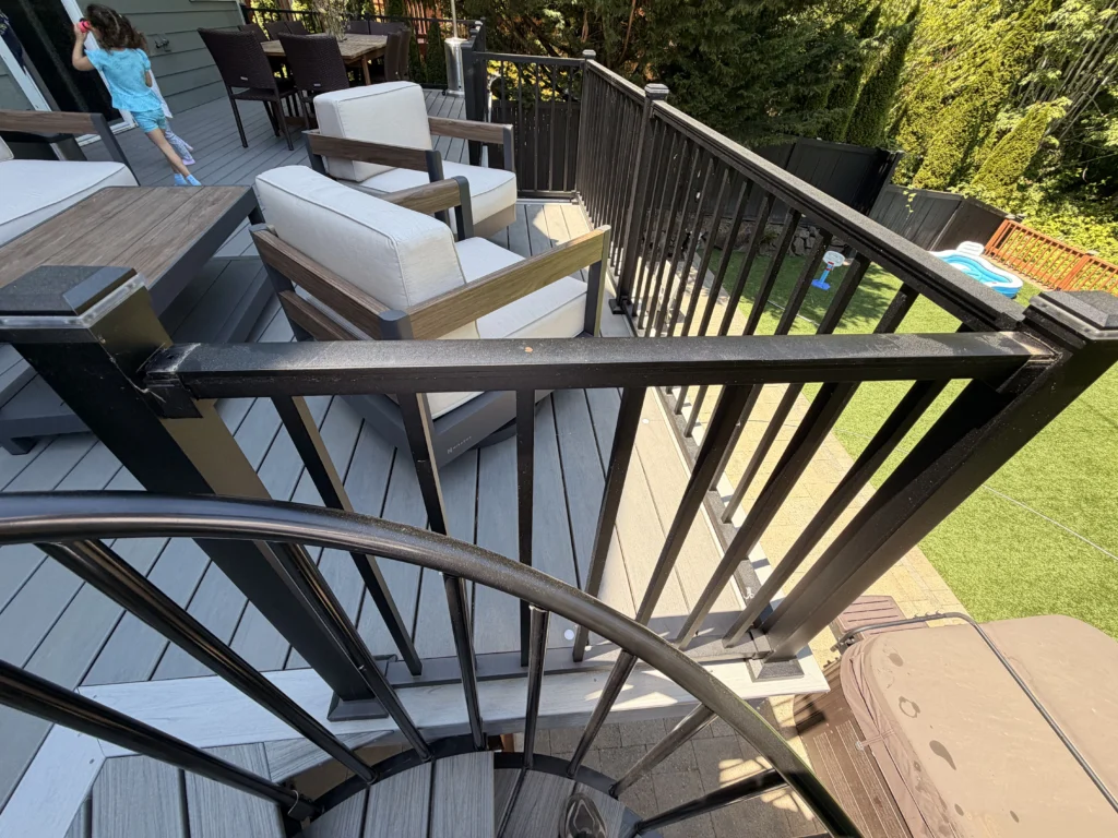 Curved Black Metal Handrails And Gray Composite Boards Featured On A Trex Deck Replacement In Issaquah.
