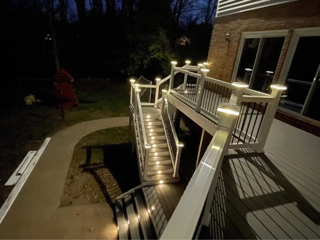Elevated Deck With Illuminated Stairs And Post Caps Beside A Brick House In Everett, Wa